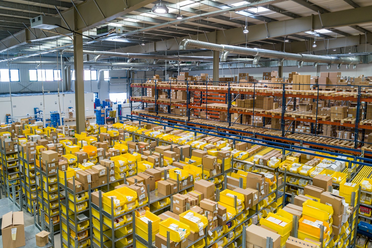 Warehouse racks with inventory boxes and pallets