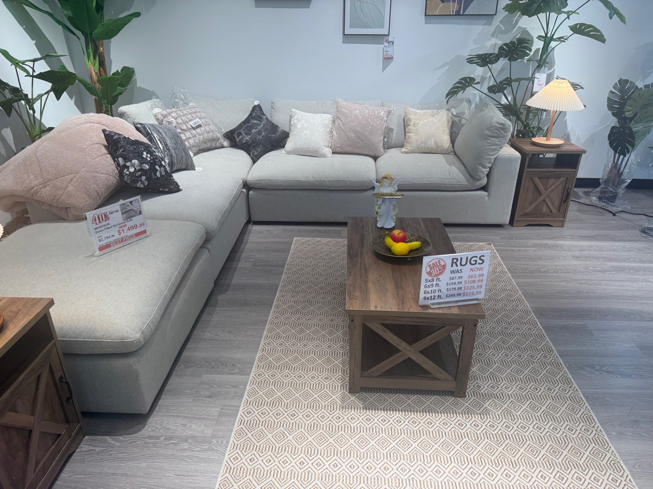 Sectional sofa, rug, pillows, table, and lamp setting